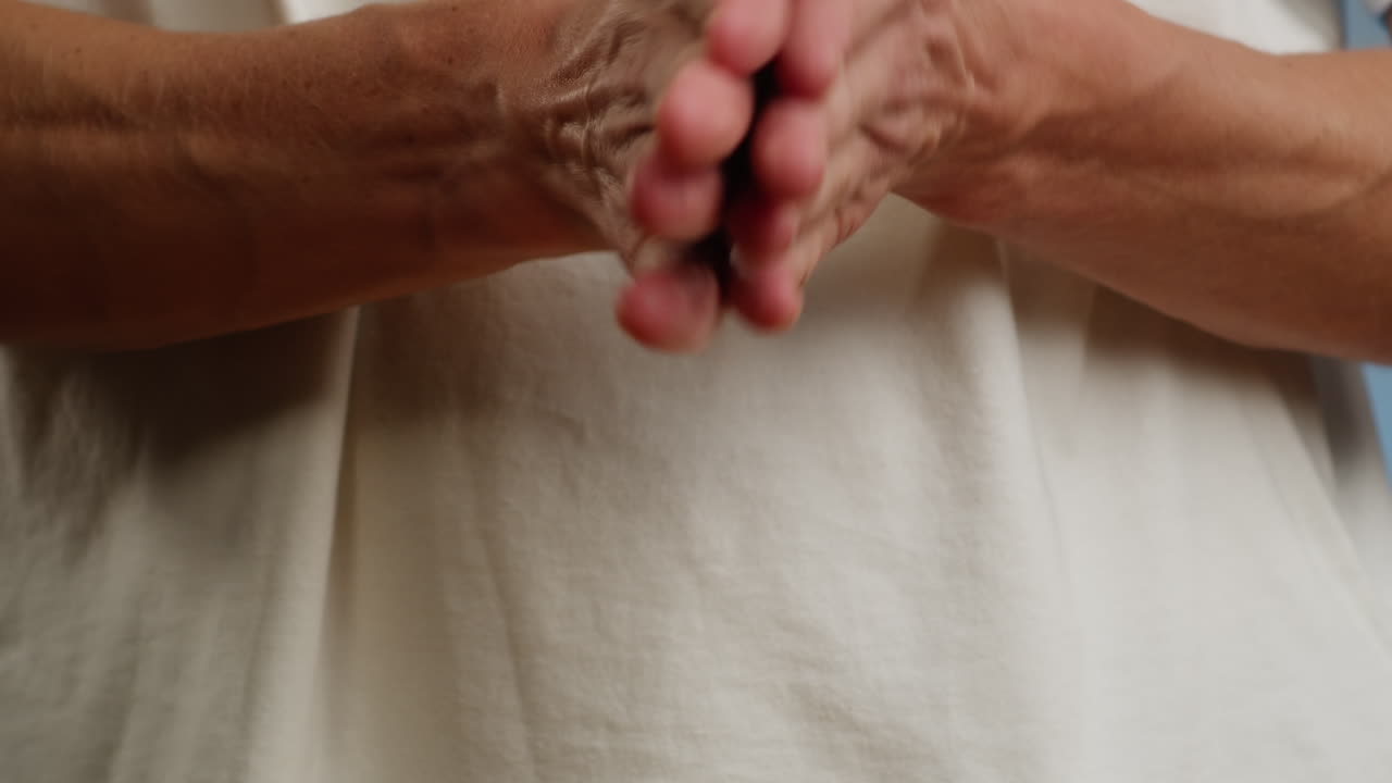Young man squeezing a yellow gel moisturizer oil from a tube on his hand close-up. Morning routine. Beauty and care concept. Skin texture.