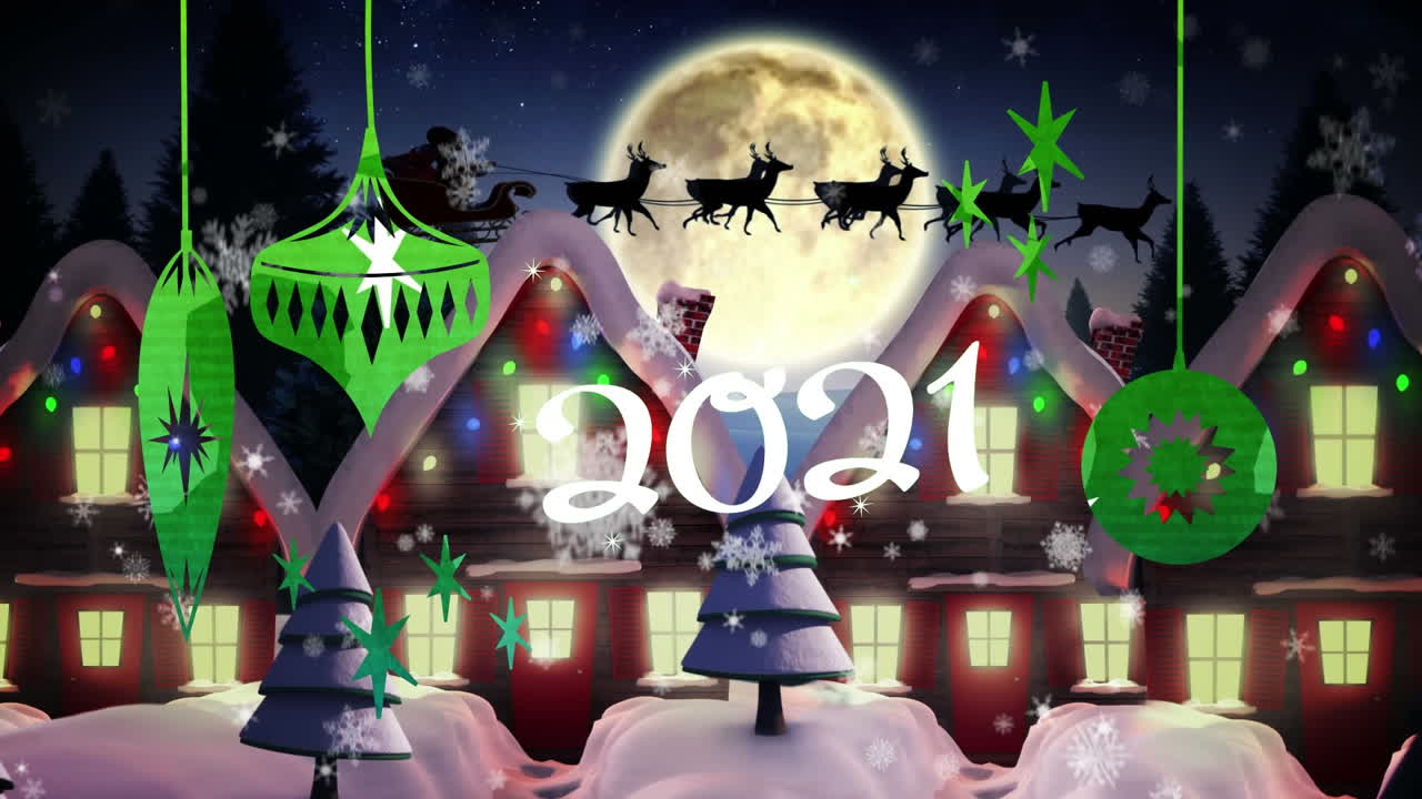 2021년 텍스트와 크리스마스 장식품이 겨울 풍경 위에 내리는 눈에 매달려 있습니다.