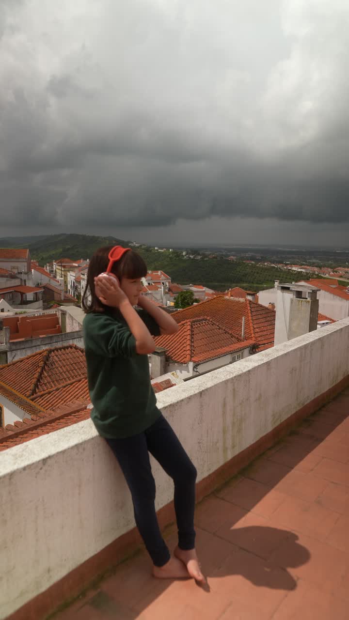 Girl with Headphones on a Rooftop