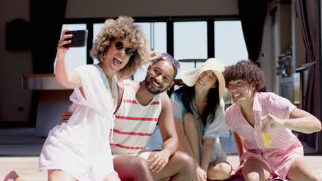 taking selfie, group of diverse friends enjoying summer hangout, smiling and posing
