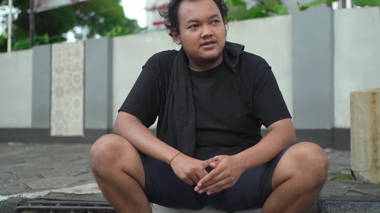 Man Sitting and Talking on the Street