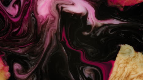 motion video of mixing of liquid pink, black, yellow, red fluid