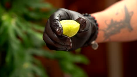 latin chef squeeze lemon wearing black gloves closeup