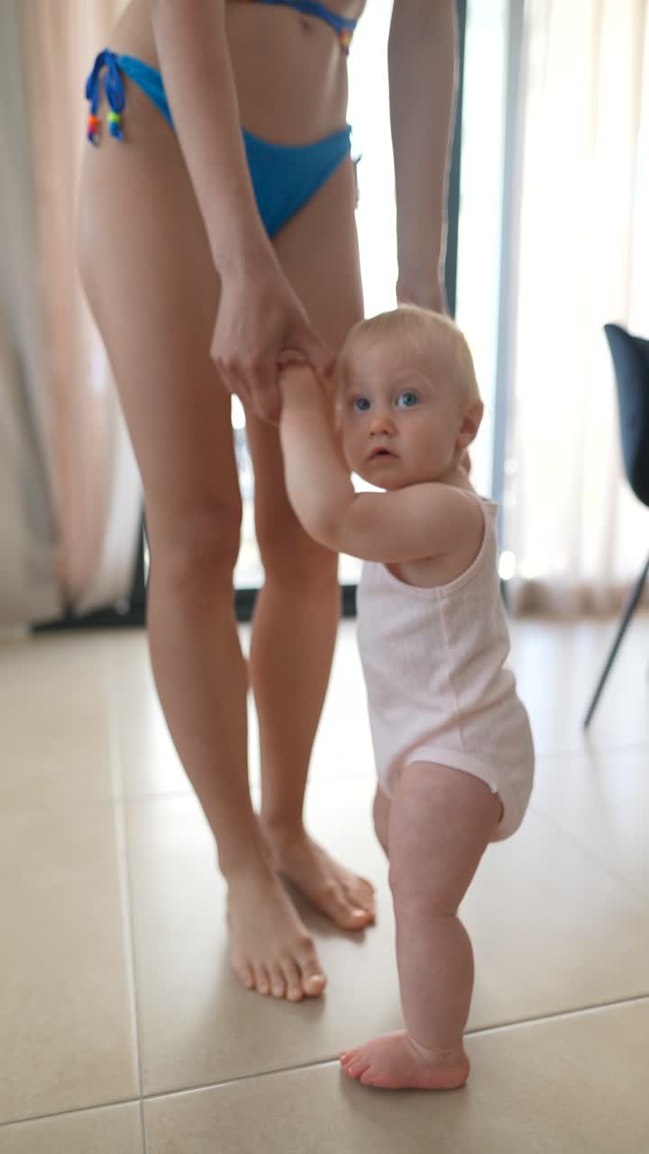 madre ayudando al bebé a caminar