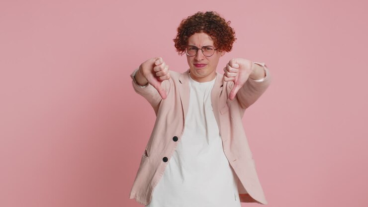 Upset man guy showing thumbs down gesture disapproval dissatisfied dislike negative feedback