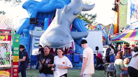 visitors enjoying a sunny day at a fair