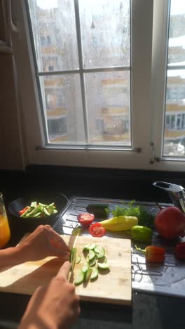 preparando una ensalada saludable en una cocina junto a una ventana