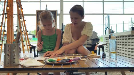 mother and daughter enjoying an art class