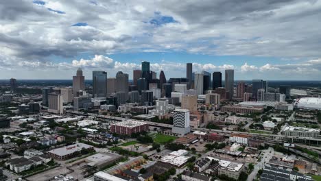 skyscrapers in houston skyline district cloudy tx, usa - circling, aerial view