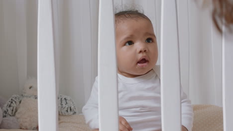 happy baby in crib cute toddler in cot smiling happy playful infant looking curious enjoying childhood life safe at home