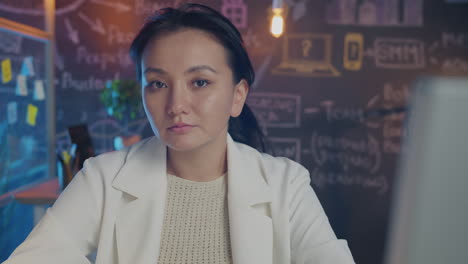 asian woman working at laptop