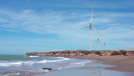 windmills turbines turning near the coast