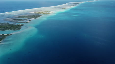 palm tree motu islands, remote atoll, french polynesia panorama aerial