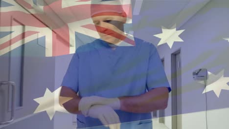 Animation-of-flag-of-australia-over-caucasian-male-doctor-walking