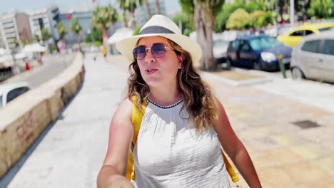 coastal athens story: tourist girl vlogging by the sea