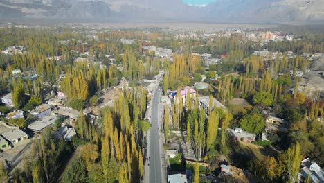 drone shot of skardu city with busy road in pakistan during sunny day