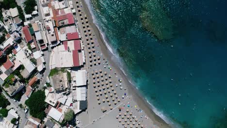 Beautiful-view-from-a-drone-flying-over-the-beach-and-bay-in-Matala-Crete-Greece