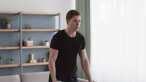 man doing dumbbell arm workout at home