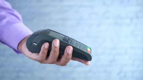 person holding a payment terminal