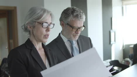 female business leader explaining financial report to colleagues