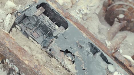 Corroded-battery-Cuban-refugee-boat-washed-up-on-seaside-shoreline