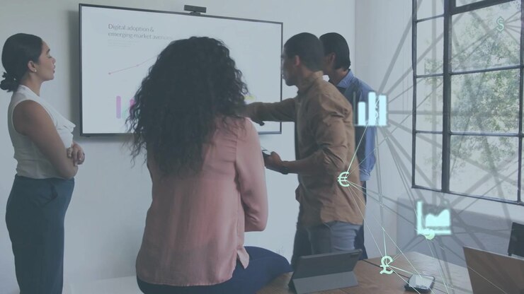 Lead tapping tablet and pointing at screen, team analyzing business charts with data icons on right