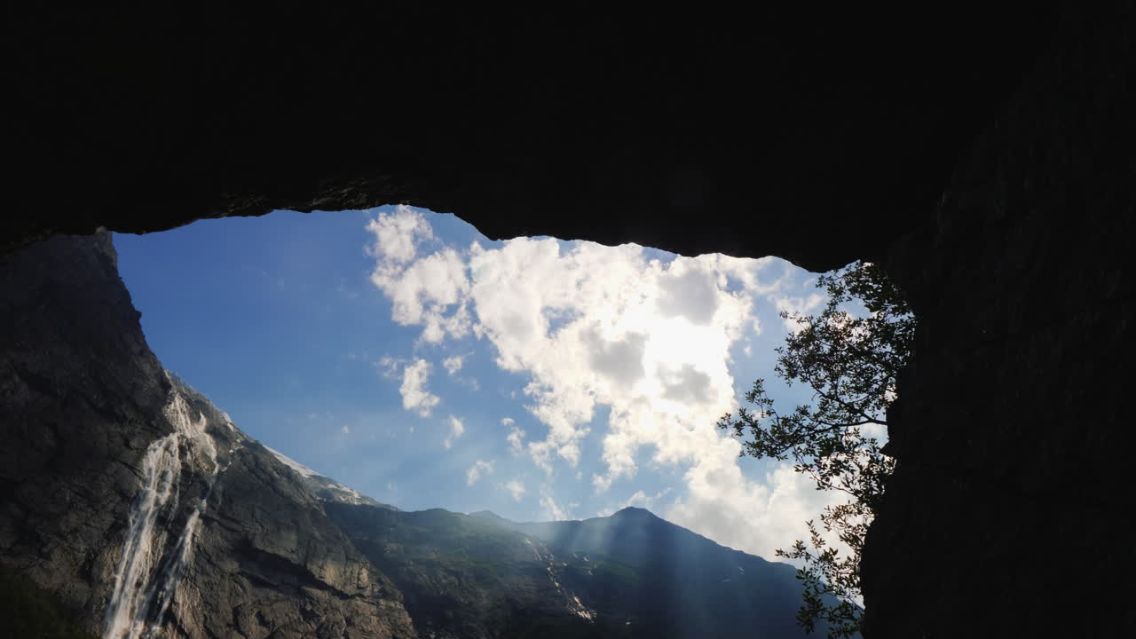 briksd 근처 상단에 폭포가 있는 높은 산까지 바위의 아치를 통해 볼 수 있습니다.