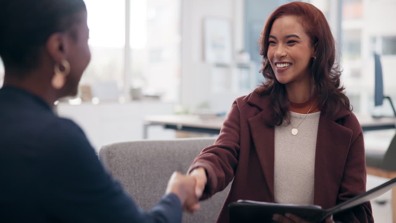 Two professional women in a business meeting or job interview
