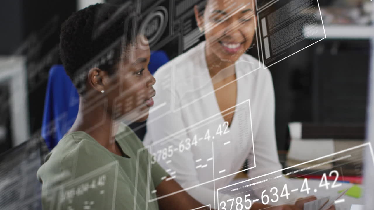 Animation of digital data processing over diverse businesswomen using laptop in office