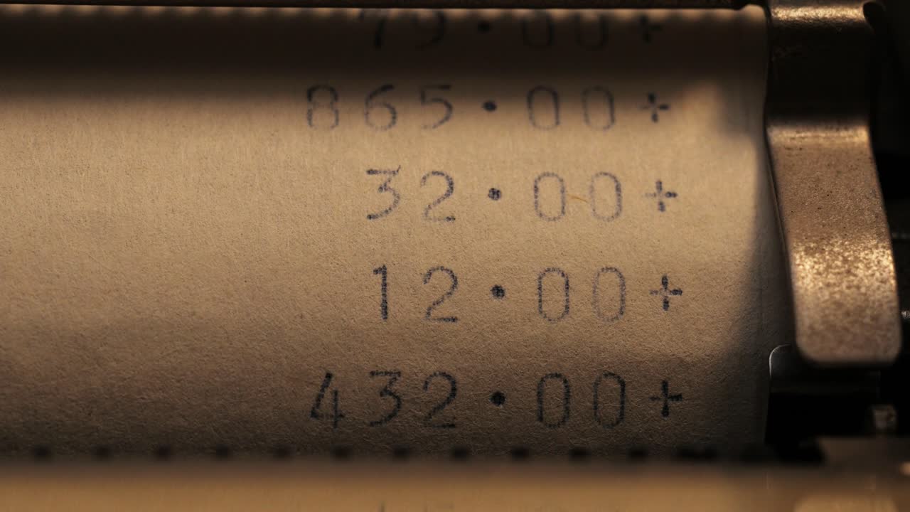 Close up of printed numbers adding up with plus symbols on a paper roll in low light