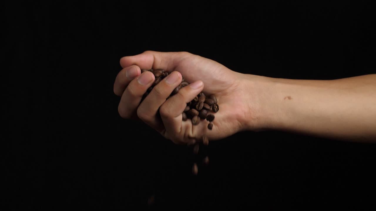 Hand Hold Fresh Roasted Coffee Beans Pouring, Slow Motion