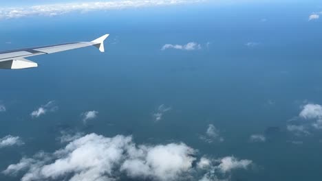 aerial view from a plane: ocean, clouds, and wing captured in a captivating journey through the skies