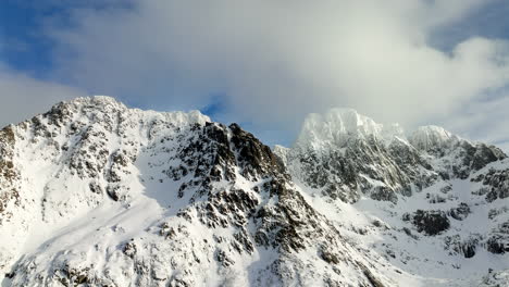 aerial drone view of stunning lofoten snowy mountains with clouds above