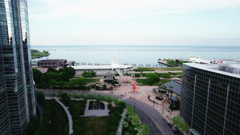 orbiting aerial of milwaukee lakefront behind a reflective building