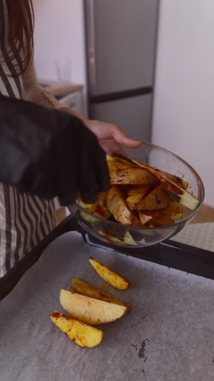 Woman preparing potato wedges in the kitchen