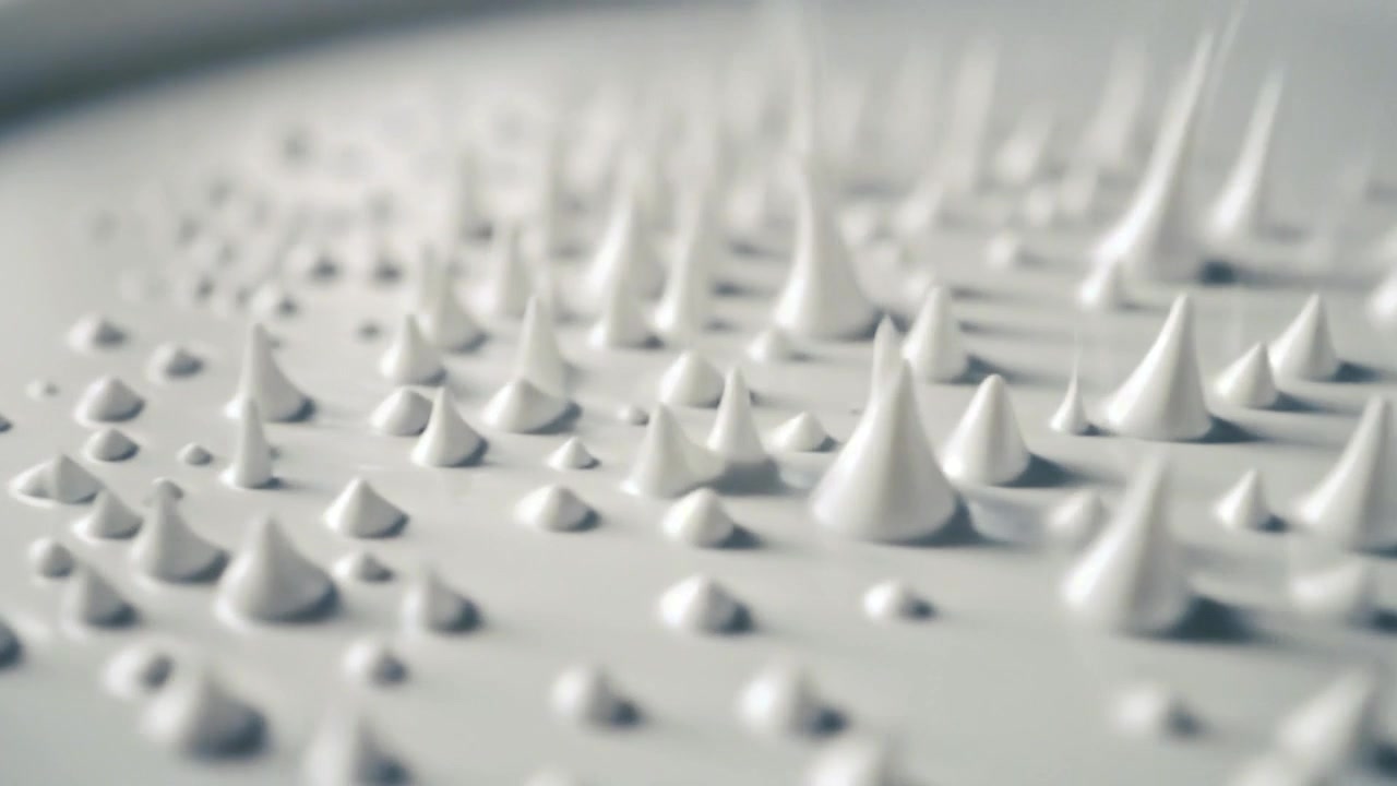 Ferrofluid Spikes Forming on a White Surface