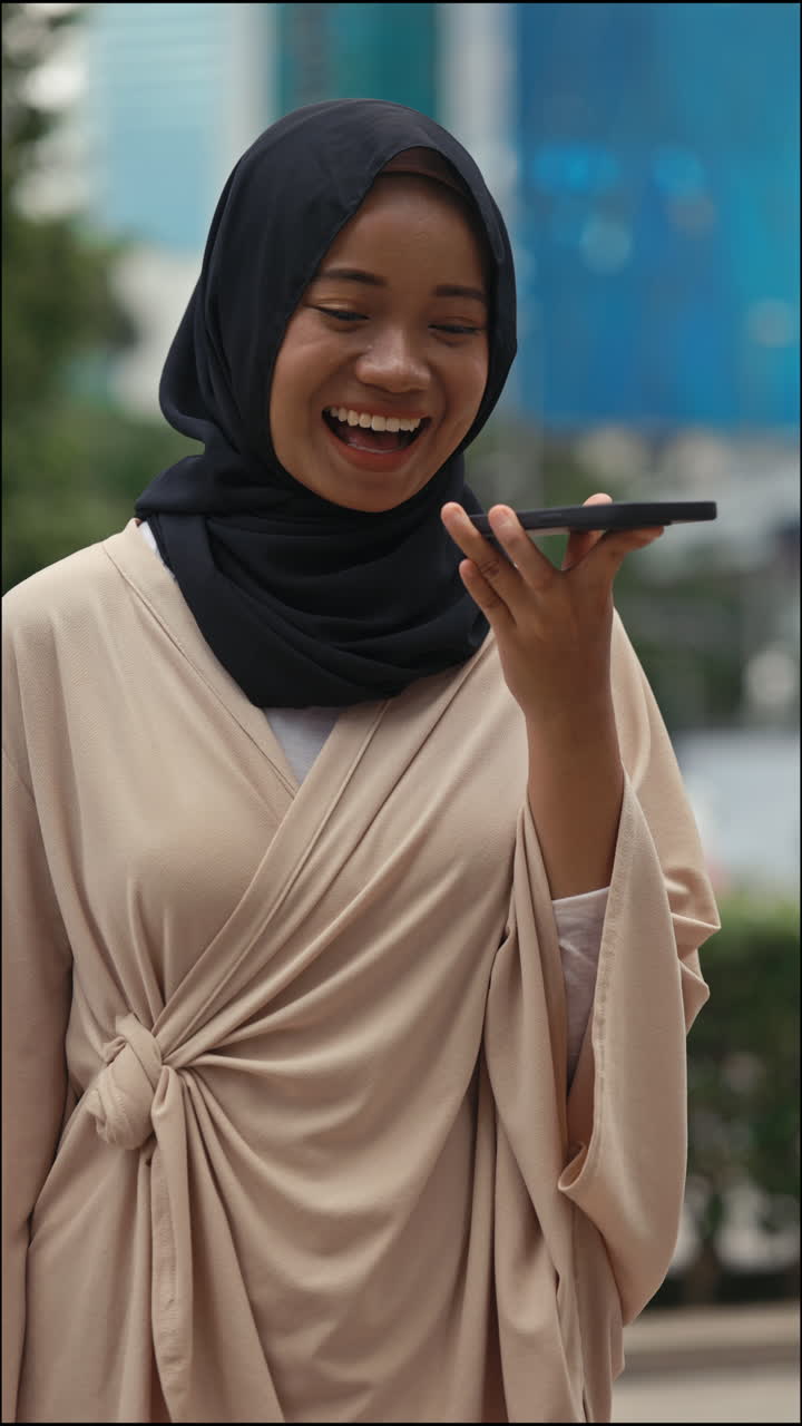 Young Woman Using Smartphone for Voice Communication Outdoors