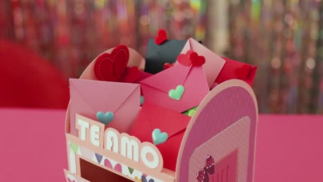 miniature paper mailbox full of lovely valentine letters with hearts