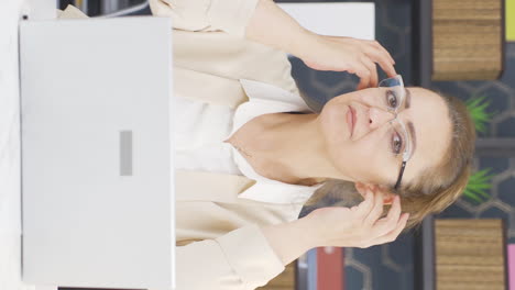 Vertical-video-of-Well-groomed-and-smiling-positive-business-woman-looking-at-camera.