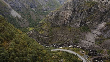 a mountain road and river goes trough a beautiful valley in western norway