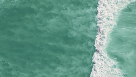 Drone-shot-of-waves-crashing-in-the-ocean