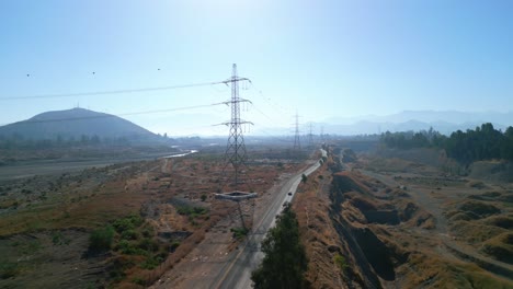 high voltage towers on the banks of the maipo, in the commune of buin, country of chile