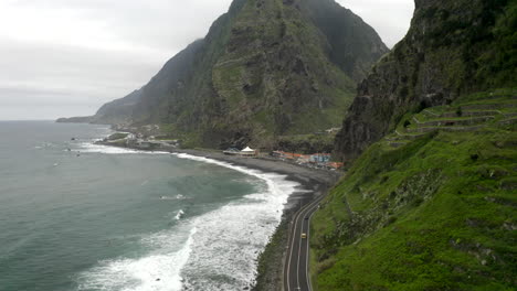 Drone-footage-along-the-North-coast-of-Maderia,-with-huge-mountains-against-the-Atlantic-coast,-in-Sao-Vicente