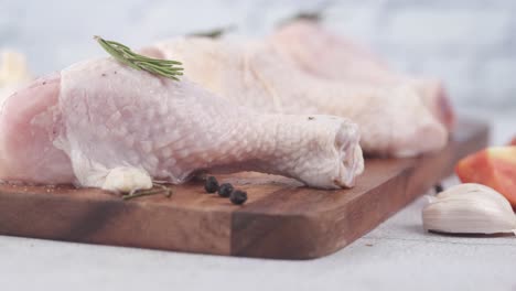 raw chicken legs with aromatics