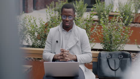 businessman working on laptop outdoors
