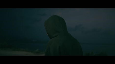 person in hoodie at night