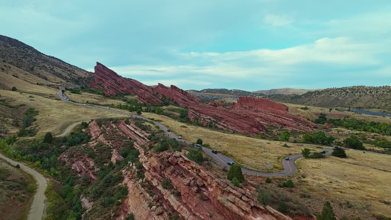 Drone aerial over Red Rocks Amphitheatre Colorado showing rugged sandstone formations under daylight sky