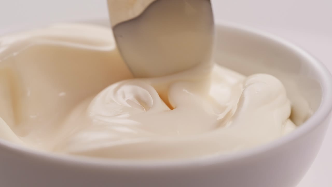 Spooning Sour Cream from a Bowl