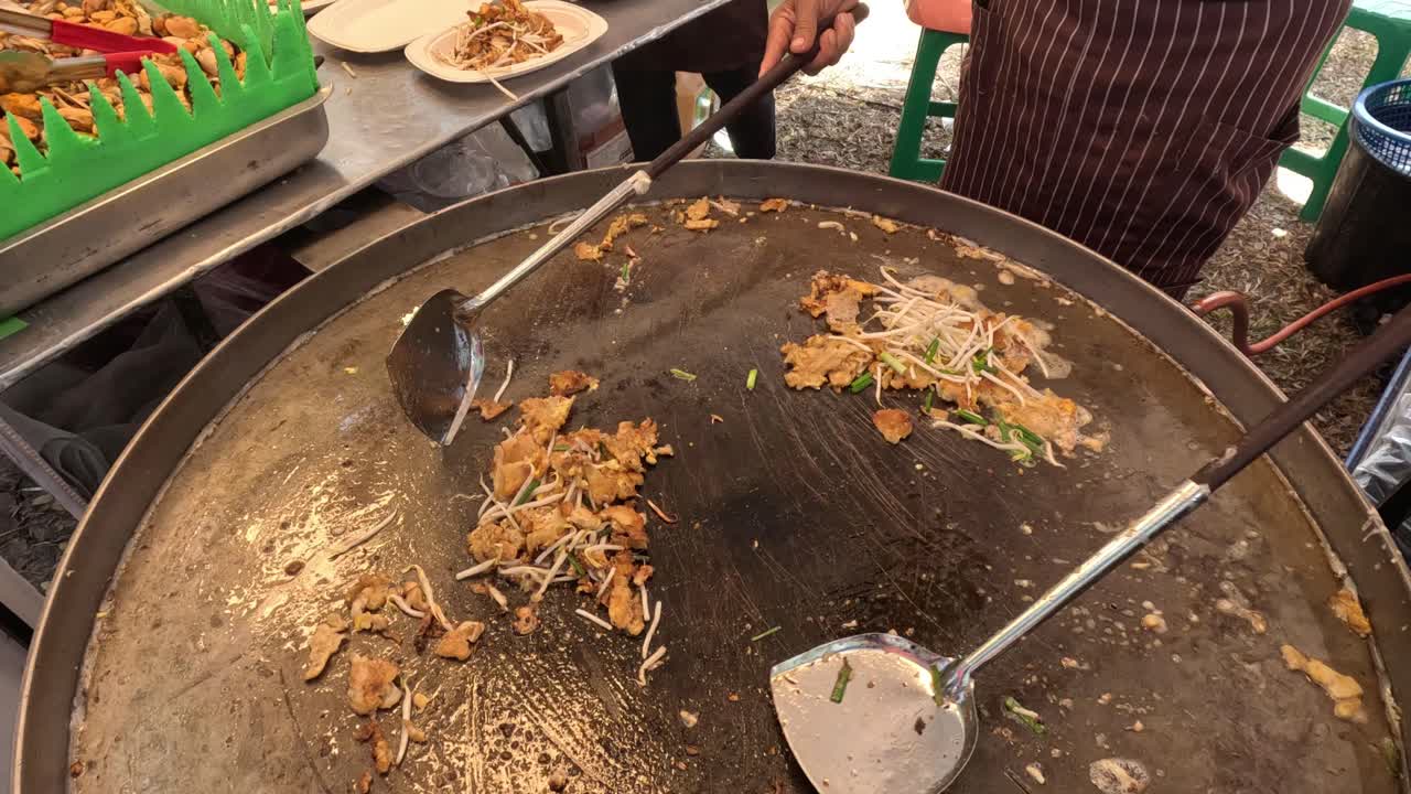Cooking noodles with vegetables in a wok.