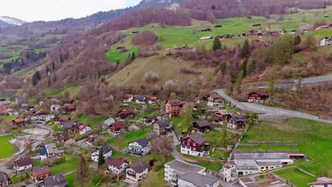 schiers, switzerland showing lush green hills and scenic village homes, aerial view